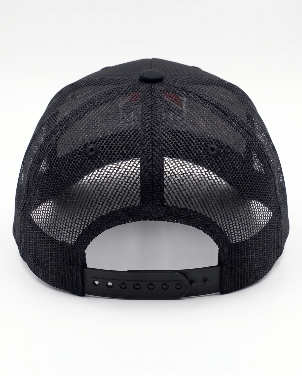 Black trucker cap shown from the back, featuring a black mesh back and an adjustable snap closure.