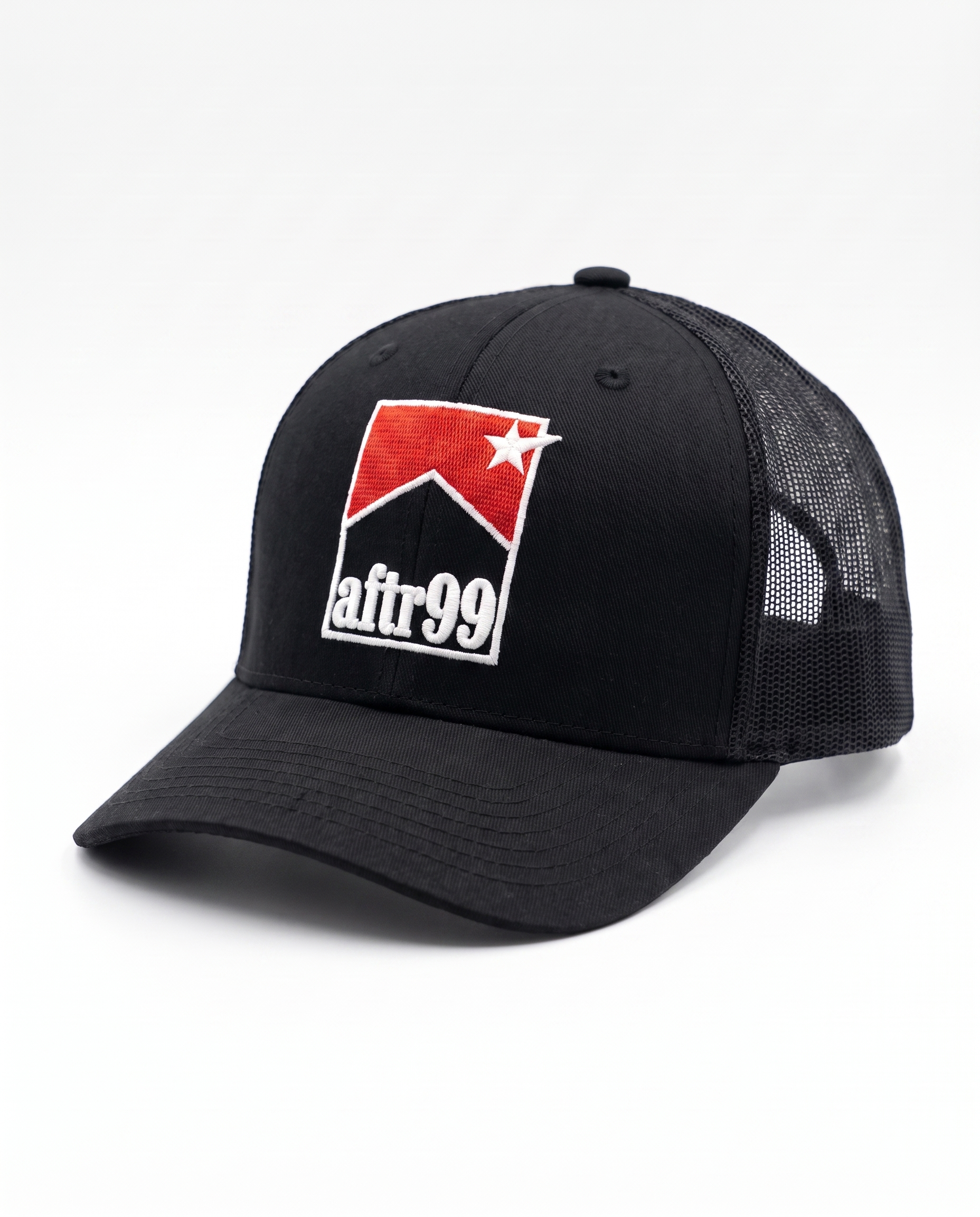aftr99 | A black trucker-style baseball cap with a curved brim, black mesh back panels, and a red, white, and black embroidered patch on the front reading 'afr99' with a star.